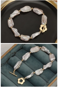 Detail of baroque freshwater pearl bracelet with golden flower toggle clasp and macro texture