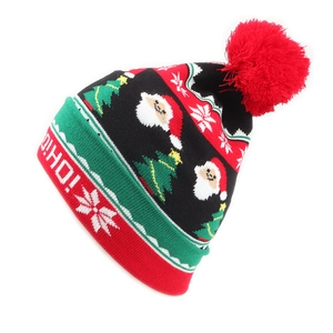 Winter knitted Christmas beanie with Santa Claus patterns and a large red pompom topper