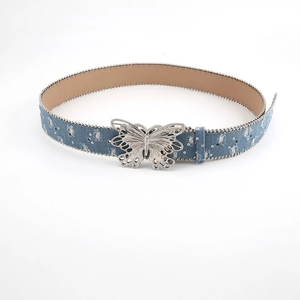 Detailed view of blue denim belt with butterfly buckle and silver rhinestone trim