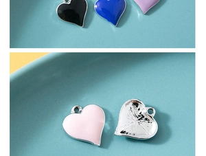 Detailed view of colorful heart charms in enamel and alloy, showing front and back texture
