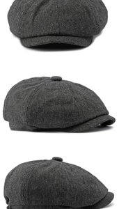 Close-up of the grey tweed texture and stitched panels on the vintage newsboy cap