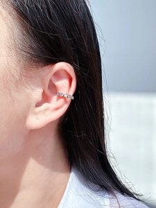 Detailed side view of silver ear cuff with white zircons for non-pierced ears