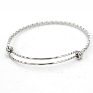 Close-up of polished stainless steel twisted coil bracelet with adjustable sliding knot