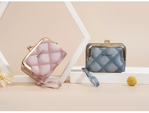 Detail of pink and blue mini coin purses with quilted texture and gold kiss-lock clasp