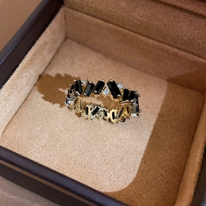 Detail of gold-plated geometric ring with rectangular black zircon and white stones