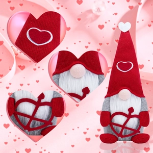 Detail view of Valentine's gnome showing knitted texture, plush beard, and heart bow accessory