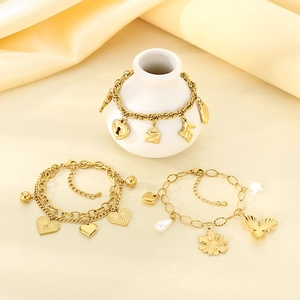 Golden stainless steel chain bracelet featuring heart lock and key charms on champagne silk