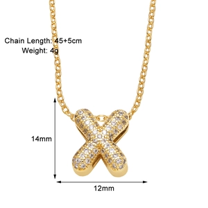 Detail of gold X letter necklace with pavé cubic zirconia and dimensions marking