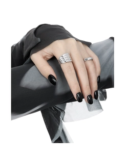 Close-up of matte silver wavy wide ring and pleated textured band on a hand