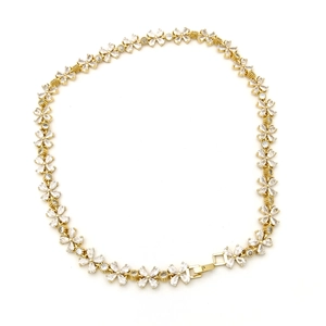 Detail of gold plated flower link necklace with pavé set white cubic zirconia stones