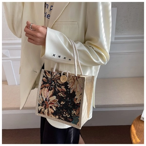 Detail of vintage linen tote with floral print, wooden button and rope handle
