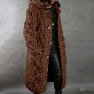 Detail of dark brown cable-knit hooded cardigan with large pockets and button texture