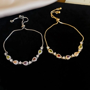 Detail of adjustable slider bracelets with colorful pear-cut zircon in gold and silver finish