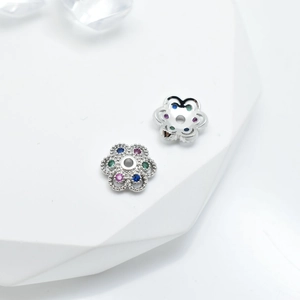 Silver flower bead spacer with colorful crystals for DIY jewelry making on white background