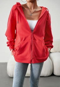 Detail of a red zip-up hoodie featuring warm fleece fabric and front pockets