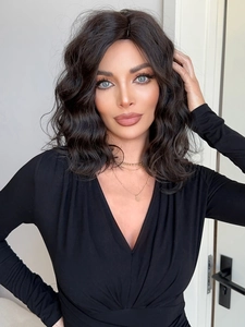 Close-up of a medium-length black wavy wig with natural curls and high-temperature fiber