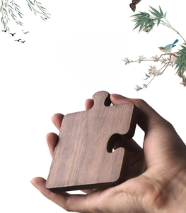 Macro shot of a puzzle-shaped walnut wood coaster showing natural grain and thick texture