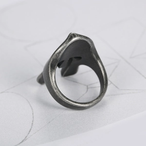 Close-up of vintage Spartan mask ring showing oxidized finish and inner band detail