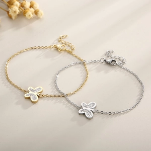 Detail of gold and silver butterfly pendant bracelets with sparkling crystal pavé settings