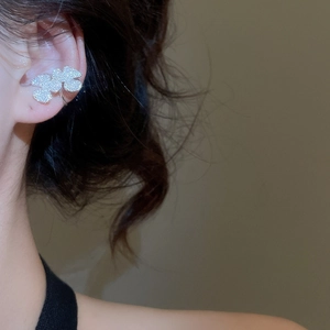 Macro view of silver petal ear cuff with sparkling zircon inlay for non-pierced ears