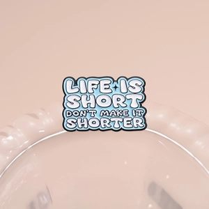Blue enamel metal brooch with 'Life is short don't make it shorter' text design
