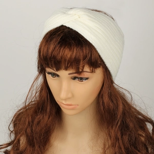 Detail of white cable knit headband showing the soft texture and twisted cross design