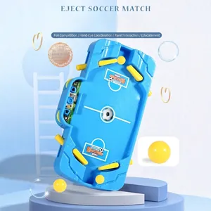 Interactive tabletop soccer game for kids featuring blue plastic pitch and yellow strikers
