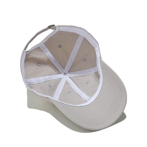 Interior detail of a breathable khaki baseball cap with reinforced seams and metal eyelets