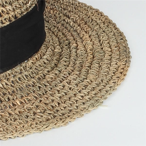 Macro detail of high-density natural straw weave and texture on a foldable sun hat