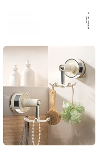 Rotating six-claw wall hook in bathroom setting holding shower brush and towel