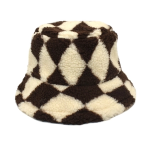 Close-up of plush plaid bucket hat texture with brown and cream diamond pattern