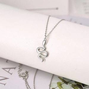 Macro shot of silver snake pendant in 925 sterling silver with a high polished finish