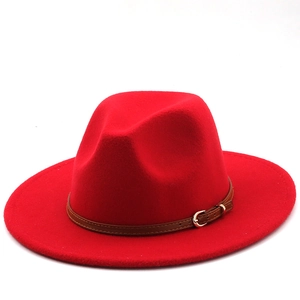 Detail of red wool felt fedora with a brown leather belt strap and gold metal buckle