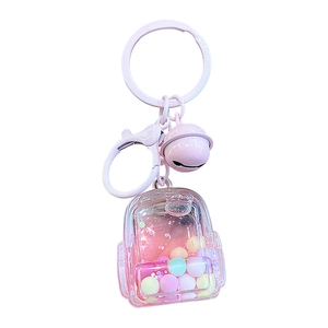 Pink liquid quicksand schoolbag keychain with colorful floating beads and a metal bell