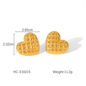 Detailed view of heart-shaped 18K gold earrings with quilted texture and dimensions