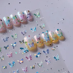 Detail of aurora butterfly nail stickers showing iridescent shift and gold foil texture