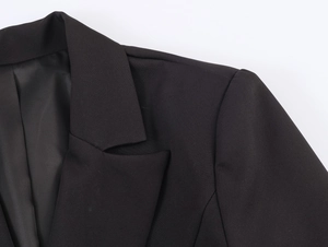Close-up of elegant black double-breasted blazer lapels and textured shoulder seams