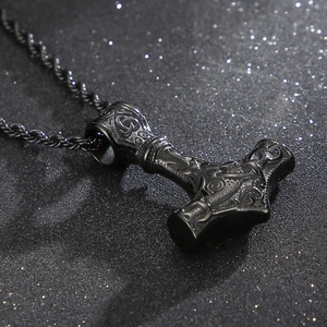 Detailed macro view of black Thor's Hammer pendant with intricate Nordic relief patterns