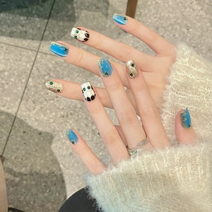 Luxury blue cat eye press-on nails with golden snake-style accents and rhinestones