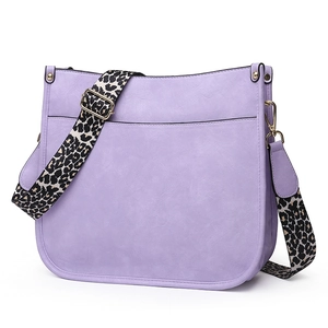 Detail of light purple faux leather tote bag with stylish leopard print wide strap