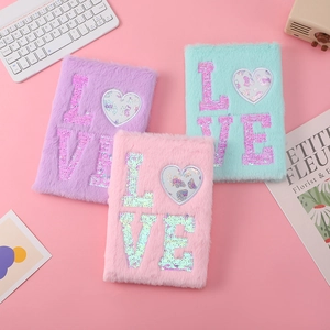 Close-up of soft faux fur cat notebooks with sequin LOVE embroidery and plush texture