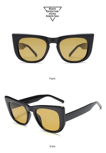 Detailed front and side view of cat-eye sunglasses with black frames and tea lenses