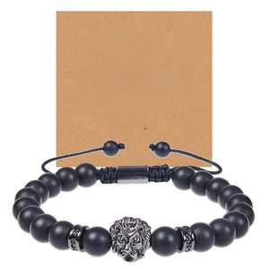 Macro detail of men's matte black stone bracelet with lion head and brother greeting card