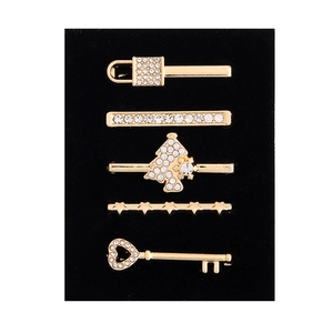 Close-up of a 5-piece gold hair clip set featuring locks, stars, and diamond charms