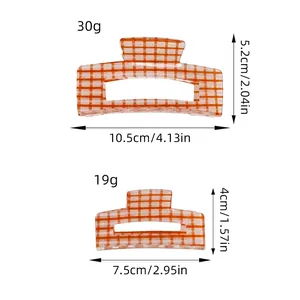 Orange and white checkered acrylic claw clips in two sizes with detailed measurements