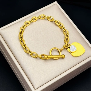 Gold stainless steel OT clasp bracelet featuring a double heart pendant with rhinestones