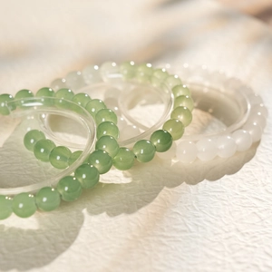 Detailed view of jasper chalcedony beaded bracelets in green and white tones