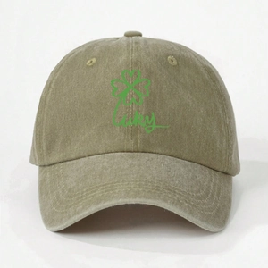 Detailed close-up of khaki washed cotton baseball cap with green lucky clover print