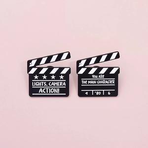 Creative black movie clapperboard metal brooch pins with cinematic action text designs