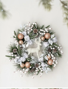 Detailed Christmas wreath featuring white reindeer, natural pine cones and champagne ornaments